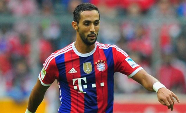 MUNICH, GERMANY - OCTOBER 04: Medhi Benatia of Muenchen challenges X of Hannover during the Bundesliga match between FC Bayern Muenchen and Hannover 96 at Allianz Arena on October 4, 2014 in Munich, Germany. (Photo by Lennart Preiss/Bongarts/Getty Images)